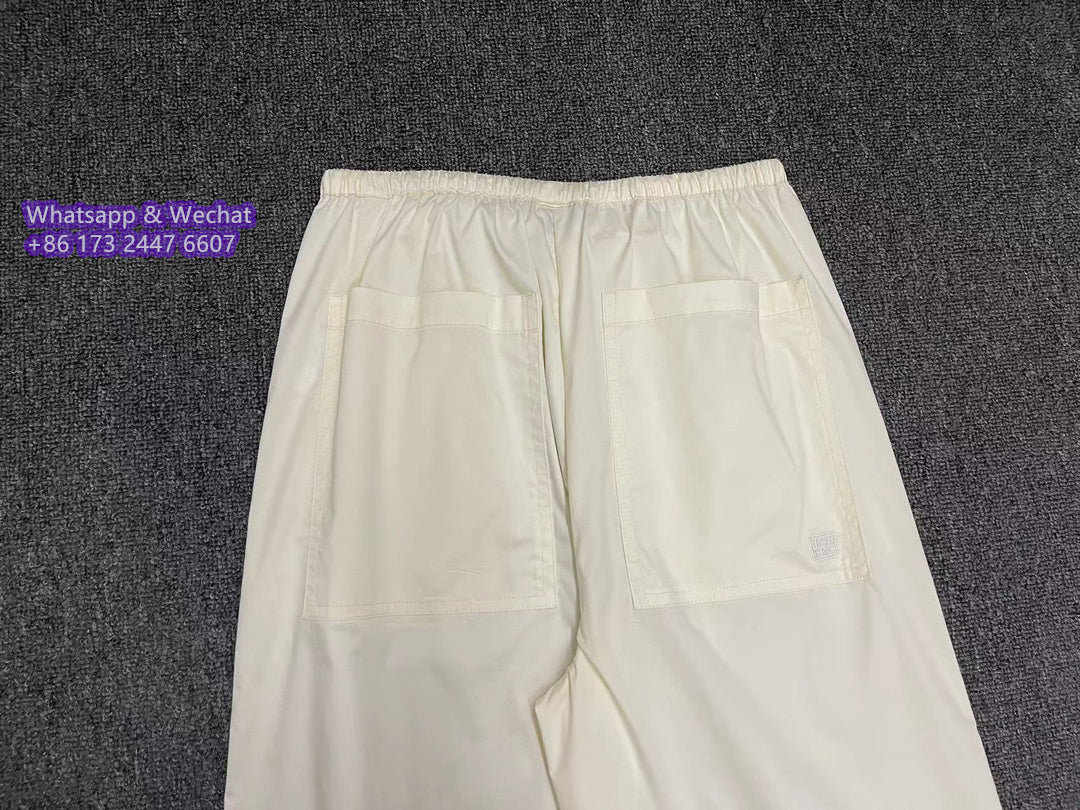Toteme straight-leg drawstring cotton trousers elasticated waistband rear pocket black beige 2410067TT
